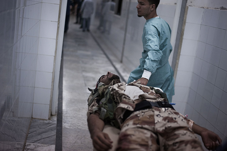 24 hours in pictures: A Libyan rebel wounded in the emergency room at hospital in Ajdabiya
