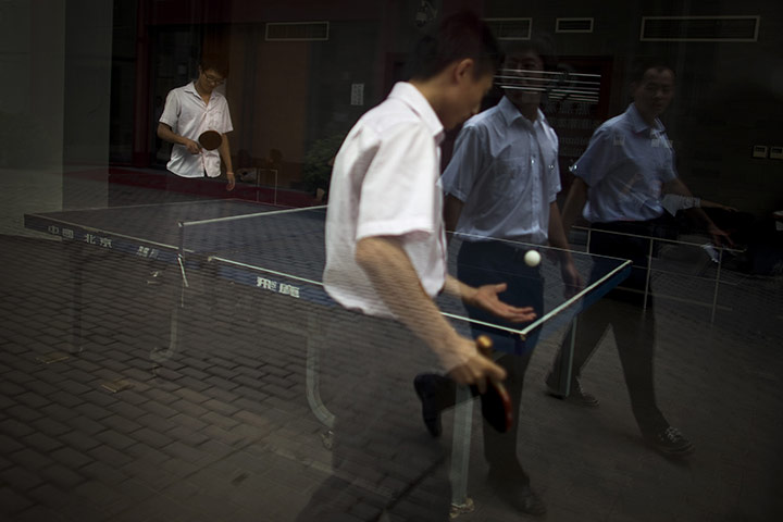 24 hours in pictures: Office workers play table tennis during their lunch break in Beijing