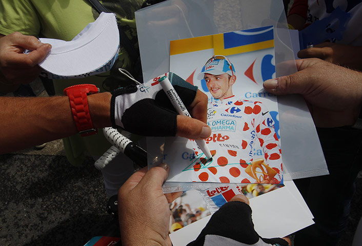 Tour de france stage 16: Best climber Jelle Vanendert signs a photo of himself for a fan