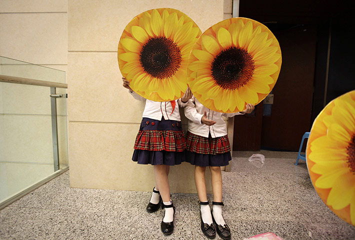24 Hours: Schoolgirls wait to perform at a concert in Chongqing municipality 