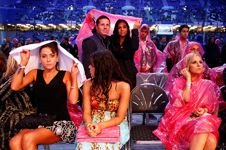 Haye v Klitschko: Spectators wait in the rain before the Klitschko and Haye fight