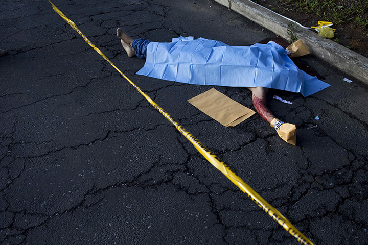24 hours in pictures: The corpse of an murder victim lies in the street in Guatemala City