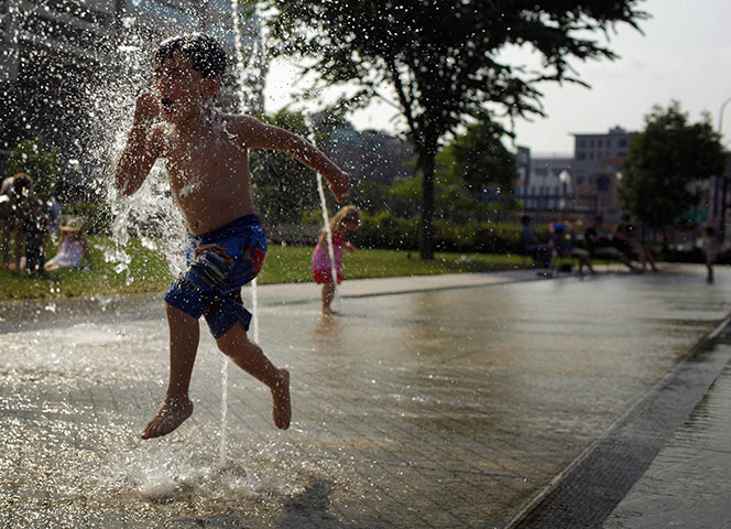 24 hours in pictures: A boy plays in a fountain on the Rose Kennedy Greenway in Boston