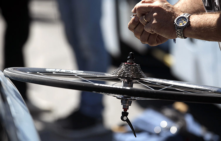 Tour de France stage 17: A technician checks a the gear cogs on a rear wheel 