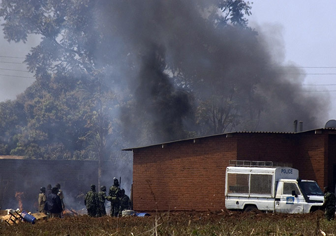 Malawi protests: Policemen watch as their fellow policemen's homes are set ablaze