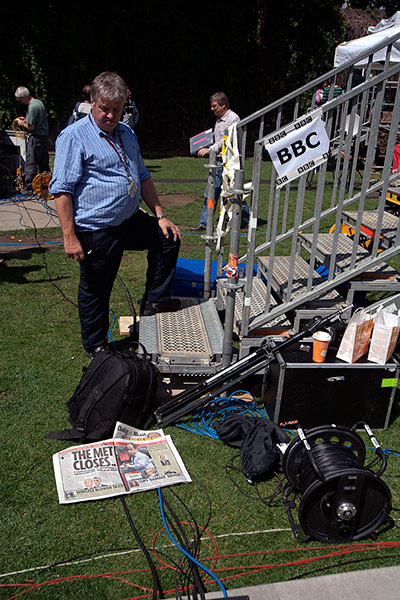 College Green media: A technician reads a newspaper 