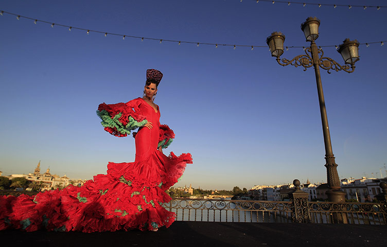 24 hours: Seville, Spain: A model in a flamenco dress walks during a fashion show 
