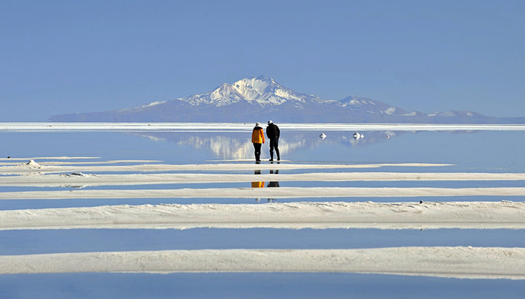 24 hours: Uyuni, Bolivia: A Japanese couple walk at the world's largest salt flat