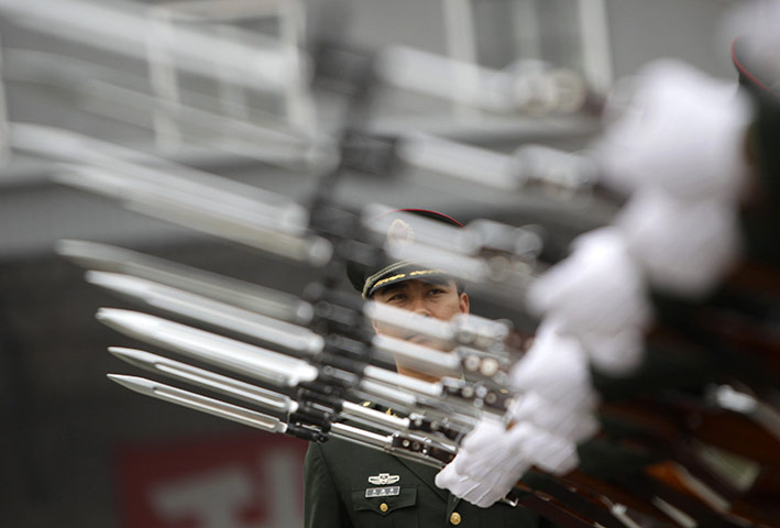 24 hours: Beijing, China: A military officer checks the posture of soldiers