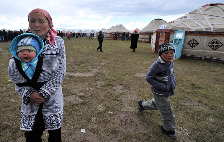 Son-Kul lake festival: A Kyrgyz woman holds a child