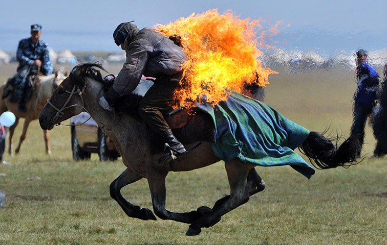 Son-Kul lake festival: A rider performs with fire