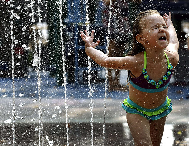 24 hours in pictures: Girl runs through a fountain in New York