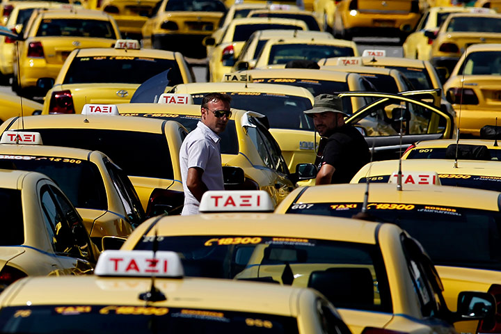 24 hours in pictures: Lines of striking taxis are parked during a protest, Athens