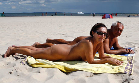 A couple of naturists sunbathe on a nudist beach in Ahlbeck on the Baltic 