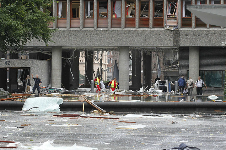 Oslo bombing: Rescue team members exit a building