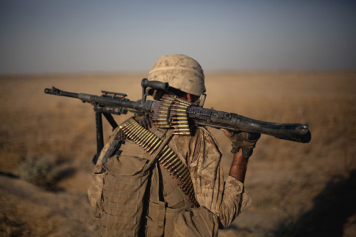 24 Hours: A US marine returns to base following a patrol in Helmand