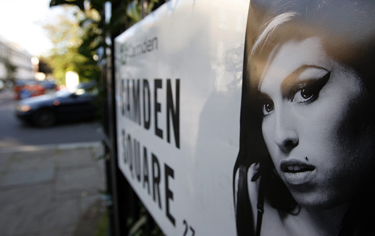 Amy Winehouse tributes: picture of singer Amy Winehouse stuck to the street sign in Camden Square 
