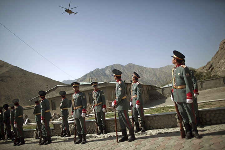 24 hours: Panjshir province, Afghanistan: Afghan honour guards watch a helicopter