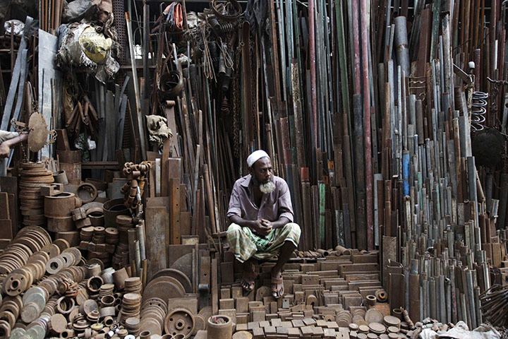 24 hours: Old Dhaka, Bangaldesh: A metal vendor sits in his shop