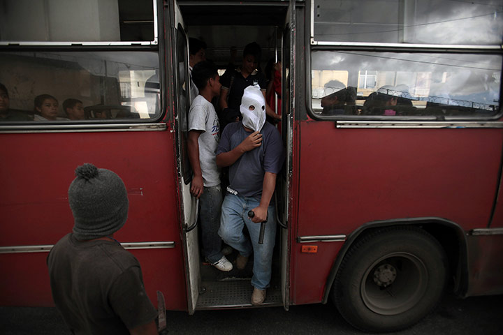 FTA: Jorge Dan Lopez: Armed villagers check a public bus entering their village of Castanas