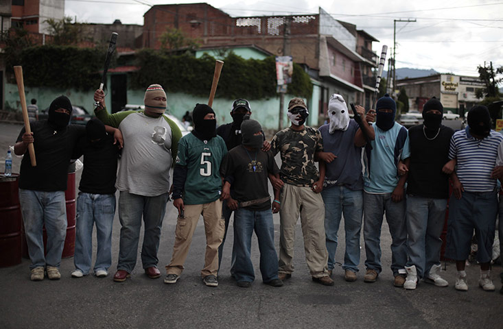 FTA: Jorge Dan Lopez: Armed villagers pose at the entrance to their village of Castanas