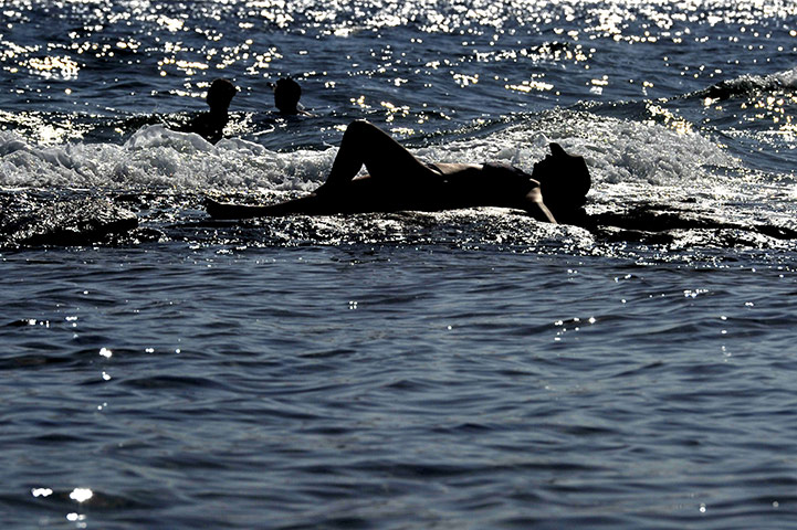 24 hours in pictures: Holidaymakers at the beach in Greece
