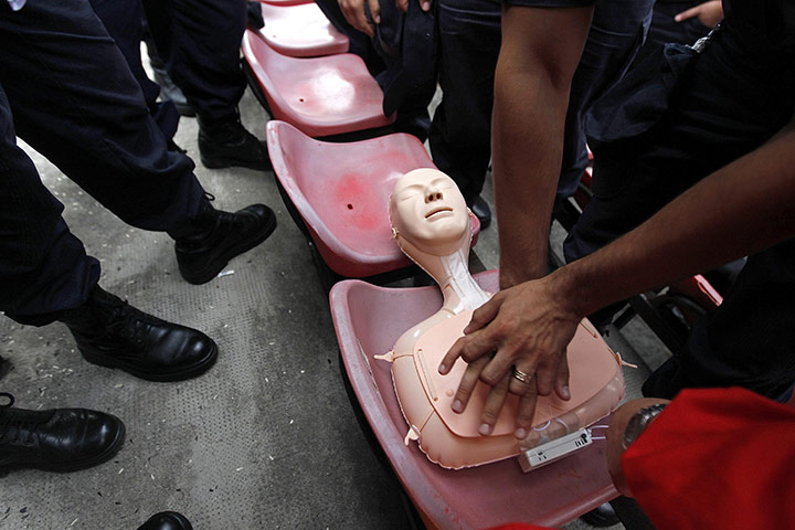 24 hours in pictures: Romanian police officers practice on a CPR training mannequin in Bucharest