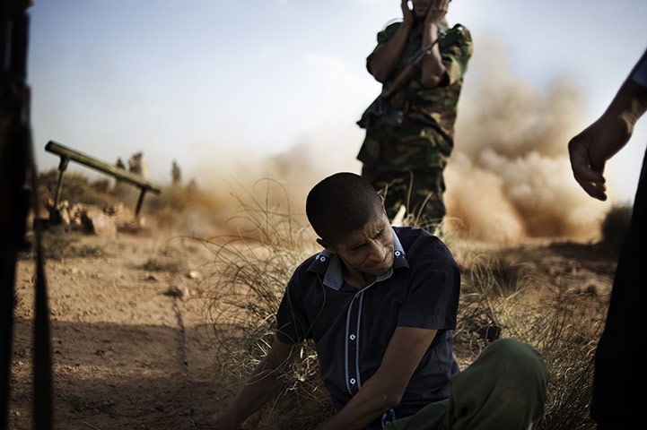 24 hours in pictures: Rebel fighters launch rockets Gualish, Libya