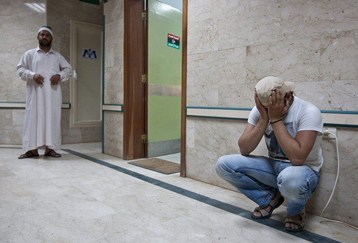 Misrata hospital: A rebel fighter learns of the death of a comrade 