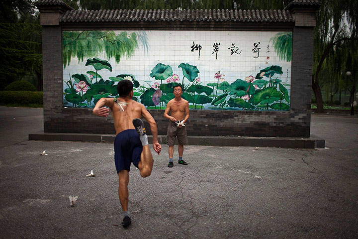 24 hours in pictures: Two men kick shuttlecocks, known as 