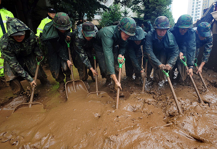 24 hours in pictures: South Korean soldiers shovel tons of mud after a flood