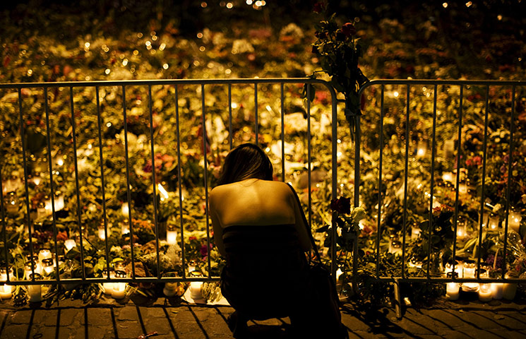 24 hours in pictures: People visit a makeshift memorial outside the Cathedral n Oslo