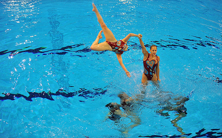 24 hours in pictures: Synchronised swimming team mark the one year countdown to London 2012