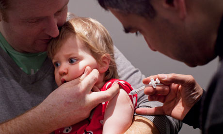 A baby is given a flu jab