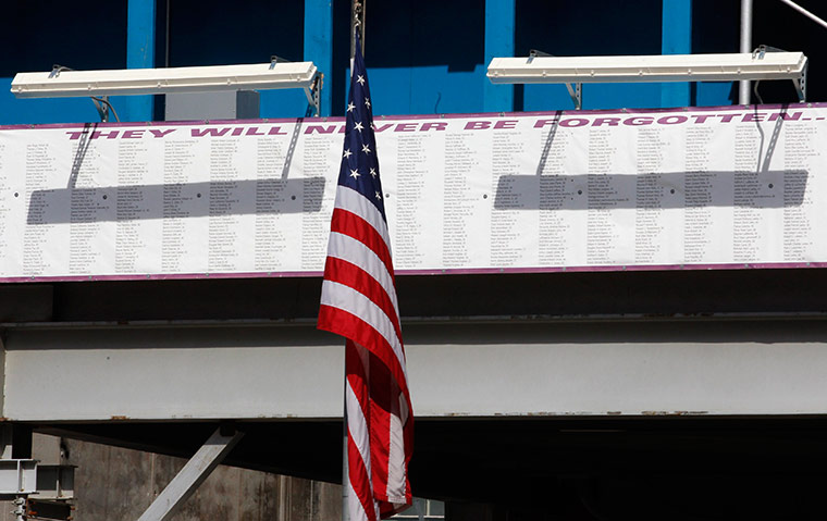 September 11 Memorial: A U.S. flag is seen near a sign with names of those lost