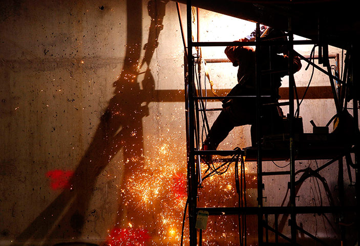 September 11 Memorial: A welder works below ground level
