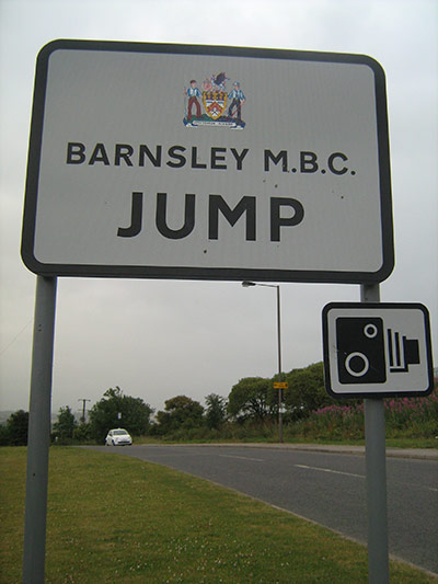 Jump: A sign post for Jump in Barnsley by Linda Moody