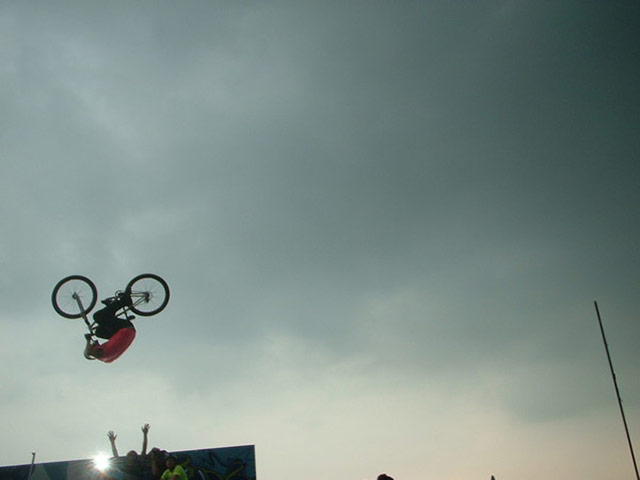 Jump: biker doing a flip by Paul Bennett