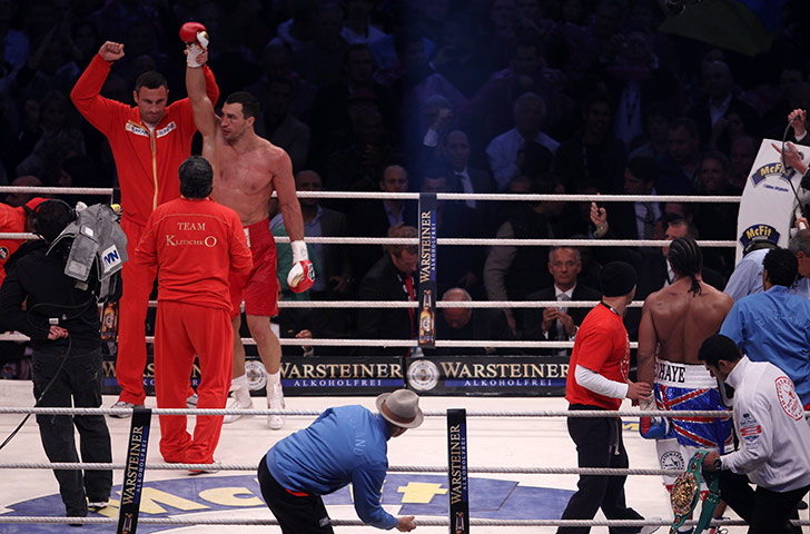 Haye V Klitschko: Vitali Klitschko raises the arm of Wladimir Klitschko in celebration