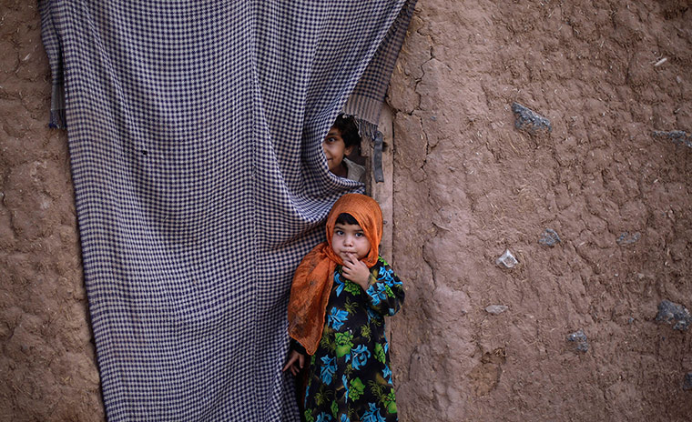 24 hours in pictures: Pakistani children at a house in a slum area