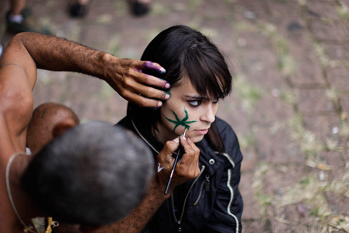 24 hours in pictures: A woman has a cannabis leaf painted on her face, Brazil