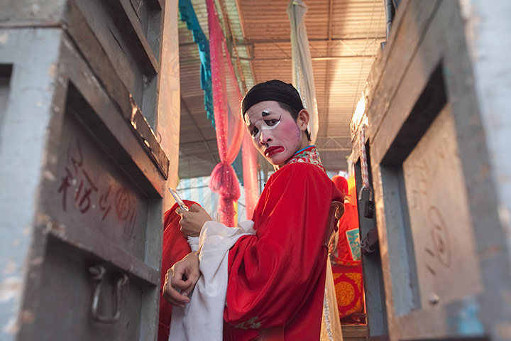 24 hours in pictures: An opera singer waits to perform in Penang, Malaysia