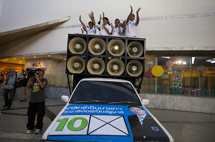 Thailand elections: Prime Minister Abhisit Vejjajiva cheers with party members