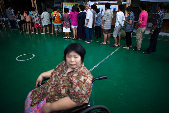 Thailand elections: Thai people wait in line before casting their vote at polling in Bangkok