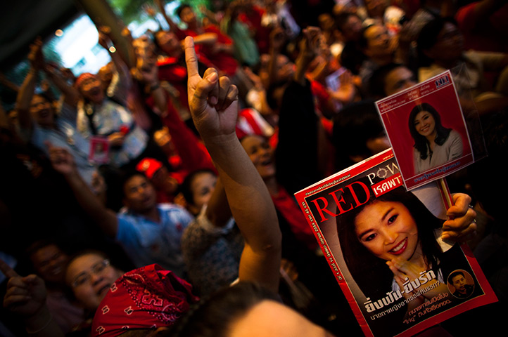 Thailand elections: Supporters of Puea Thai party hold pictures of Yingluck Shinawatra