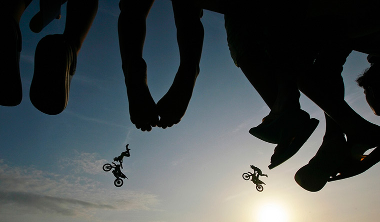 24 hours in pictures: Spectators watch as freestyle motocross stunt riders, Columbo