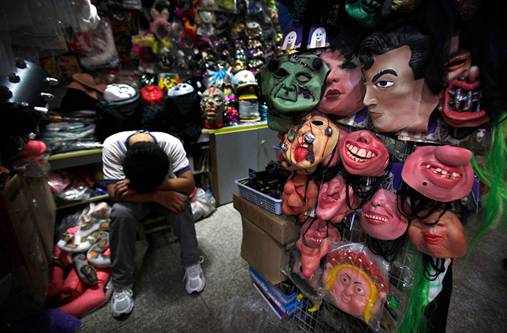 24 hours in pictures: A sales clerk takes a nap at a shop selling masks in Beijing