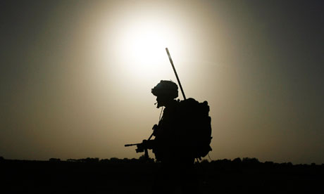 A British soldier from A Company, 2 Mercian patrols in Babaji village in Helmand province