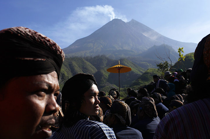 24 hours: Yogyakarta, Indonesia: Villagers sit during the Labuhan ceremony
