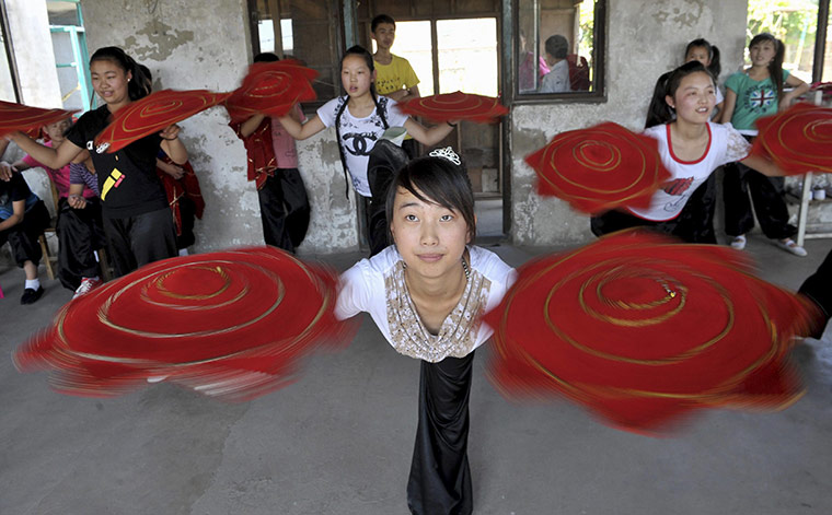 24 hours: Xinmin, China: Students practise at an Er Ren Zhuan folk art school